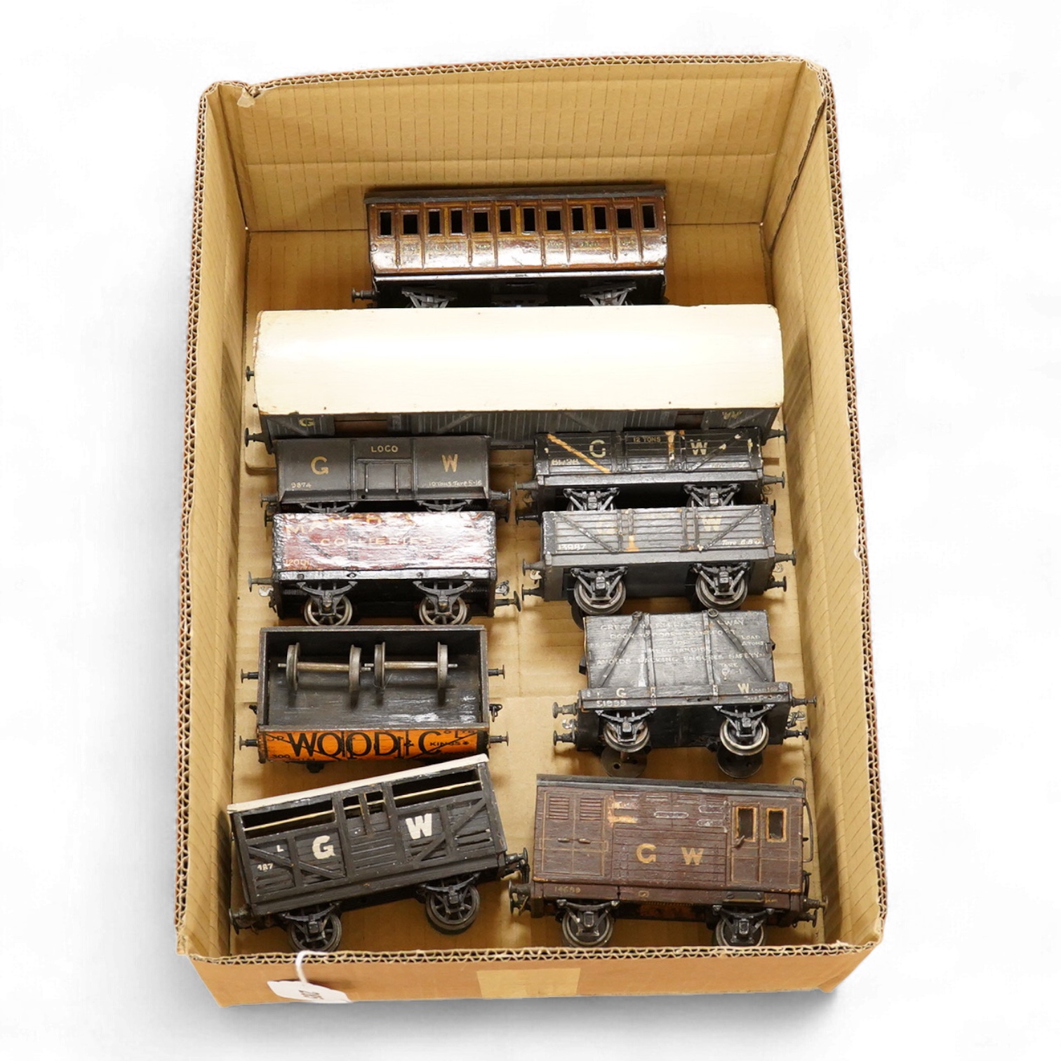 Nine 0 gauge railway coarse scale GWR and private owner freight wagons, mainly of wooden construction, together with a Bing GNR 6-wheel suburban coach (10)